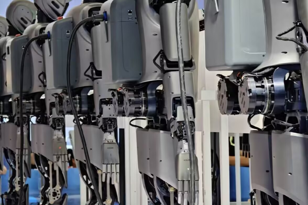 Humanoid robot prototype with visible cables, connector areas, body panels, and accessory mounting structures